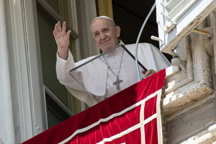 Pope Francis waves from his window overlooking St. Peter’s Square during an Angelus address. Credit: Vatican Media.