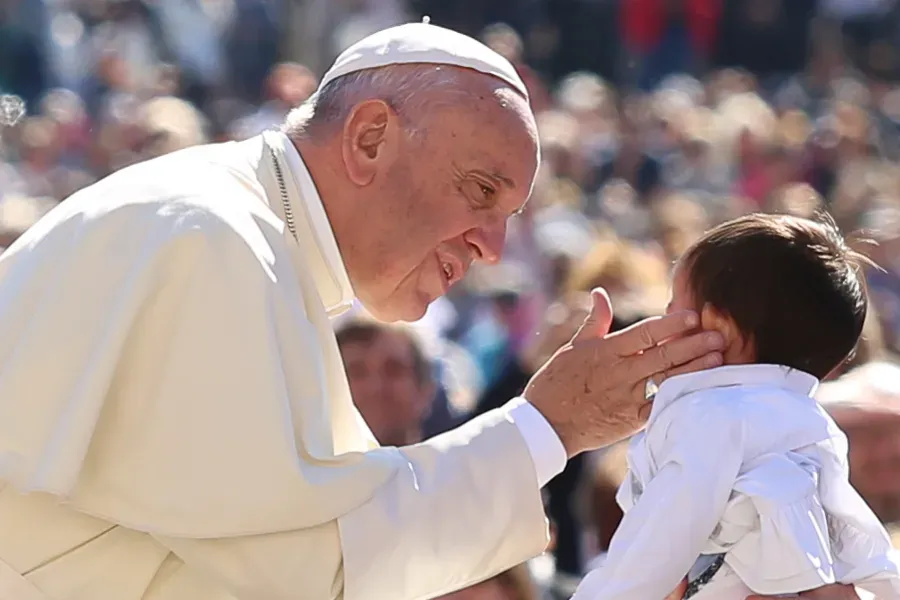 Pope Francis greets a child at a general audience at the Vatican, April 20, 2016. Vatican Media.