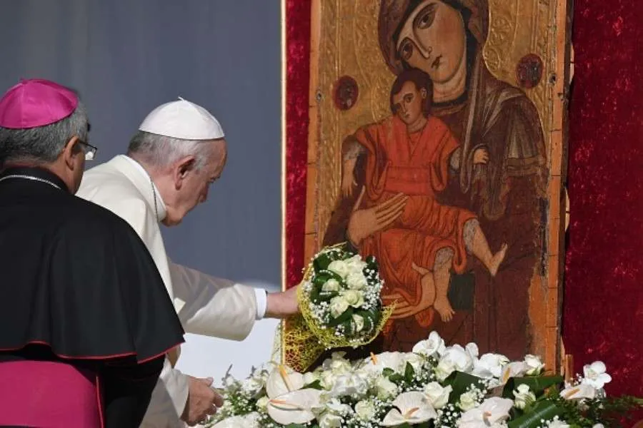Pope Francis places a bouquet before a Marian icon in Piazza Armerina, central Sicily, Sept. 15, 2018. Credit: AFP via Getty Images