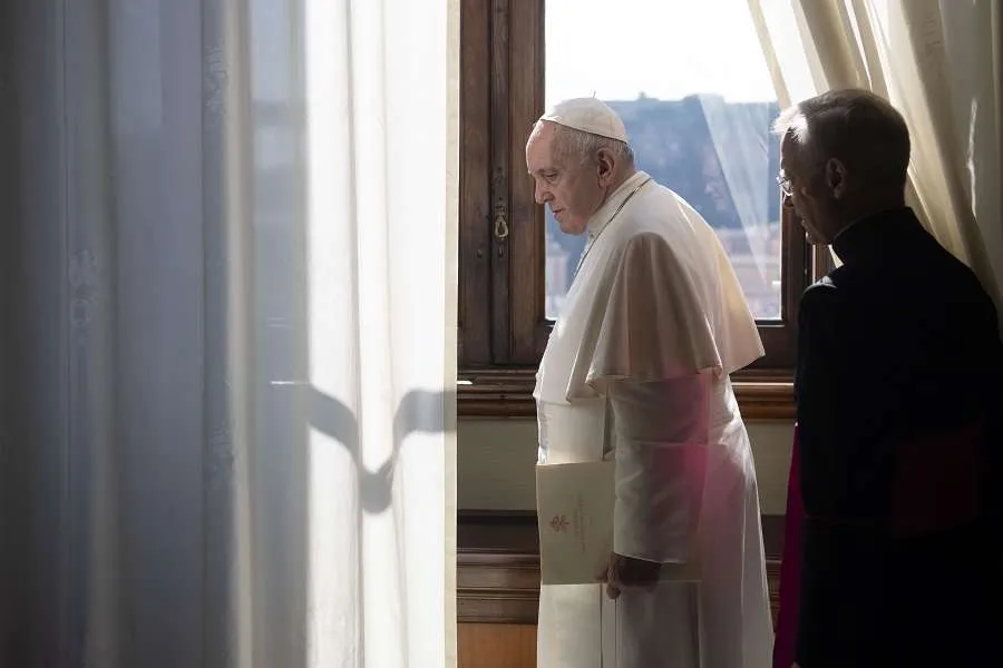 Pope Francis looks out a window of the apostolic palace March 18, 2020. Credit: Vatican Media.