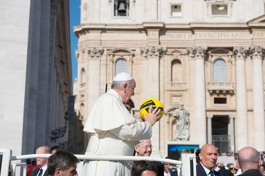 Pope Francis holds a soccer ball in St. Peter's Square in 2015. Credit: Vatican Media.