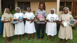 Sisters of the Congregation of the Handmaids of Divine Redeemer (HDR) posing with some of the Books they presented to Fr. Patrick Tindana, Director of Mission of Office of the Accra Archdiocese at the Holy Spirit Cathedral, Adabraka, Accra, Ghana / Mission Office, Accra Archdiocese