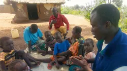 Catechists praying with refugee children in South Sudan. Credit: Aid to the Church in Need