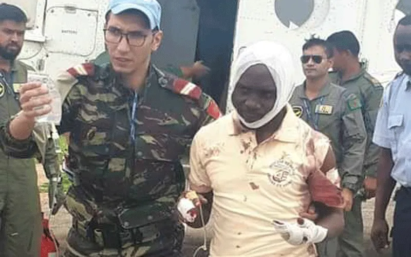 Injured Fr Guy-Robert Mandro being taken to hospital by officials of the United Nations Organization Stabilization Mission in the DRC (MONUSCO).