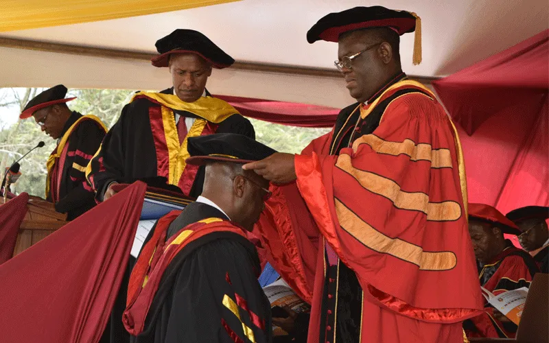 The University Chancellor, Rt. Rev. Charles Kasonde confers a doctorate degree to a graduand during the 38th Graduation at the Catholic of Eastern Africa, Langata, Oct 25, 2019 . / Catholic University of Eastern Africa (CUEA)