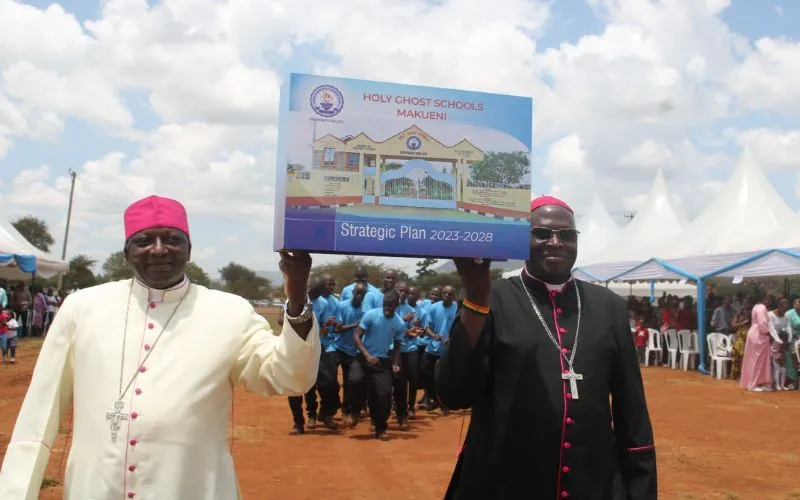 Bishop Paul Kariuki Njiru of Wote Diocese in Kenya (left) and Bishop John Mbinda of Kenya's Lodwar Diocese (right) display a demo version of the 2023-2028 Strategic Plan for the Holy  Ghost Schools - Makueni in Wote Diocese on 10 February 2024. Credit: ACI Africa