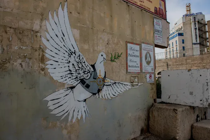 The famous Banksy’s Armored Dove of Peace, the painting of a peace dove wearing a flak jacket. The dove is painted on a wall near the separation wall between Bethlehem (Palestinian Territories) and Israel. Nov. 18, 2023. | Credit: Marinella Bandini