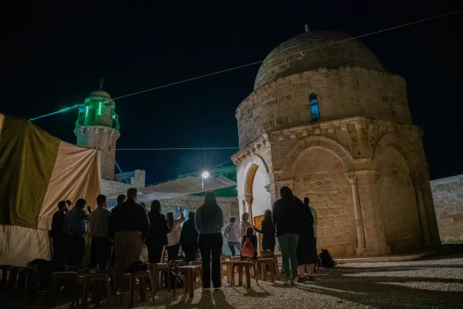 A group of faithful outside the Chapel of the Ascension on the Mount of Olives in Jerusalem, during the vigil celebration by the Franciscans of the Custody of the Holy Land, on the occasion of the solemnity, on the night of May 8, 2024.