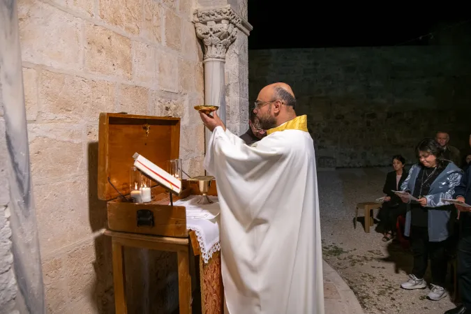 A priest during the celebration of the Ascension Mass at one of the portable altars placed outside the Chapel of the Ascension on the Mount of Olives in Jerusalem, during the night between May 8 and 9, 2024.
