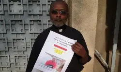 Fr. Ludovic Lado holding a poster of those detained as a result of the Anglophone crisis. Credit: Fr. Ludovic Lado