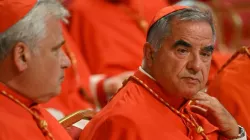 Italian Cardinal Giovanni Angelo Becciu (right) waits prior to the start of a consistory during which 20 new cardinals are to be created by the pope, on Aug. 27, 2022, at St. Peter's Basilica in the Vatican. | Credit: ALBERTO PIZZOLI/AFP via Getty Images