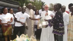 Fr. Andrew Campbell, Irish Divine Word Missionary Priest working in Ghana and helping cured Lepers with some volunteers distributing items to some cured lepers in Nkachina in the Yendi Diocese. At the Background is Archbishop Emeritus Gregory Ebo Kpiebaya of Tamale Archdiocese.