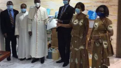 Archbishop John Bonaventure Kwofie of Accra receiving Personal
Protective Equipment (PPE) from Major-General Peter Sangber-Dery, the Supreme Subordinate President of the Knights of St. John International in Ghana at a ceremony at the National Catholic Secretariat, Accra on June 23, 2020. / Department of Social Communications, NCS, Accra