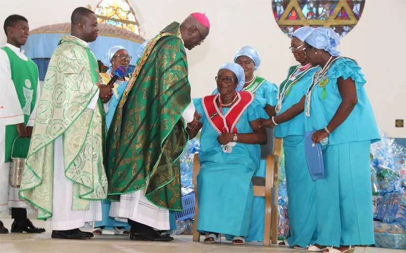 Archbishop John Bonaventure Kwofie, Apostolic Administrator of the Sekondi-Takoradi Diocese congratulating Dame Theresa Arkhurst after her installation as the 8th National President of the St. Theresa of the Child Jesus Society at the Star of the Sea Cathedral at Takoradi on November 17, 2019. / Damian Avevor