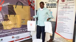 Mr. Gilbert Mutuku, the first grand winner of KomeshaCorona Challenge collects his gift hamper from Radio Shahidi offices. / Radio Shahidi/ Facebook