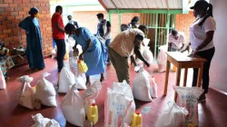 Staff of the Jesuit Urumuri Centre (JUC) prepare food items for vulnerable families in Rukiri II cell, a village in Remera sector, Rwanda. / Jesuit Urumuri Centre (JUC).