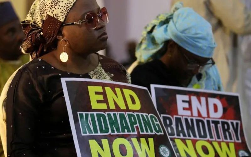 A demonstrator holding a sign during a protest against insecurity in Nigeria. Credit: Vatican News