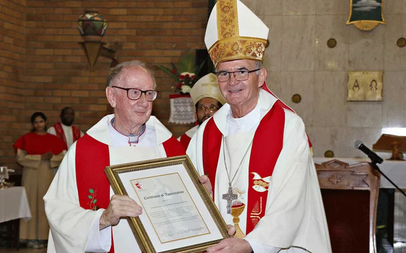 Archbishop Stephen Brislin (right) presents Msgr Barney McAleer (left) with a framed certificate in gratitude for his work in Southern Africa.