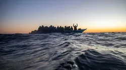 Migrants on an overcrowded boat awaiting help/ Credit: Courtesy Photo