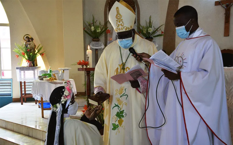Bishop George Desmond Tambala of the Diocese of Zomba handing over the Bible to Sr. Luciette Marie after she had taken her final vows. / Diocese of Zomba