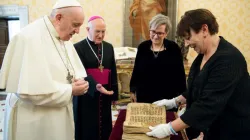 Pope Francis is presented with an Aramaic prayer manuscript at the Vatican Feb. 10, 2021. Photo credits: Vatican Media/Ufficio Stampa FOCSIV.