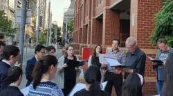 Carolers gather outside Melbourne Assessment Prison on Christmas Eve, 2019 / John Macauley/CNA