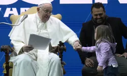 Pope Francis greets a young girl at a conference on Friday, May 10, 2024, on the state of birth rates in Italy and the wider West at the Auditorium della Conciliazione in Rome. / Credit: Vatican Media
