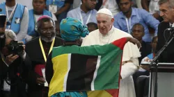 Pope Francis greets a young woman as he leads an interreligious meeting with young people at the Maxaquene Pavilion in Maputo, Mozambique, Sept. 5, 2019.
