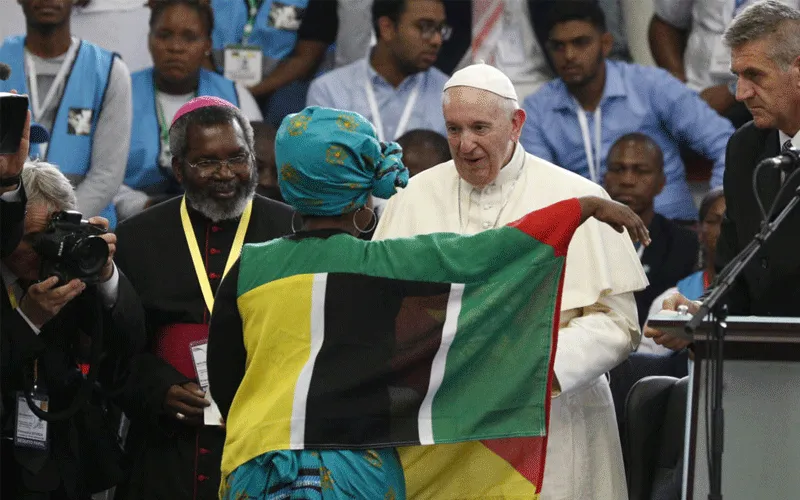 Pope Francis greets a young woman as he leads an interreligious meeting with young people at the Maxaquene Pavilion in Maputo, Mozambique, Sept. 5, 2019.