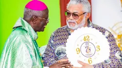 Archbishop John Bonaventure Kwofie of Accra thanking  former Ghanaian President Jerry John Rawlings for attending the 75th Anniversary celebration of the St. Paul parish at Kpehe in Accra on February 9, 2020. / Damian Avevor