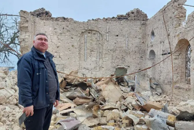 Father Oleksandr Repin among the church ruins | Benedictine Missionary Sisters