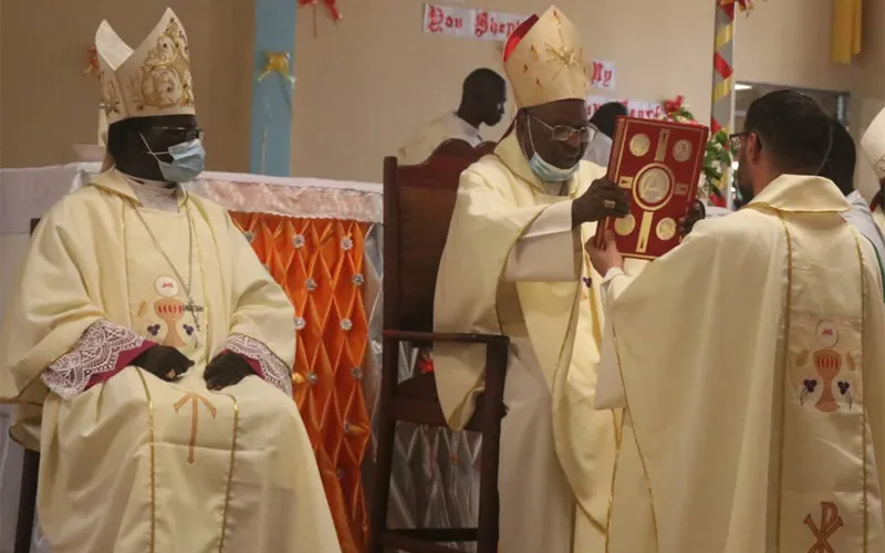 Bishop Carlassare receives the Holy Bible from Gabriel Cardinal Zubeir Wako during the March 25 Episcopal Ordination held at Holy Father Cathedral of the Diocese of Rumbek. Credit: Courtesy Photo