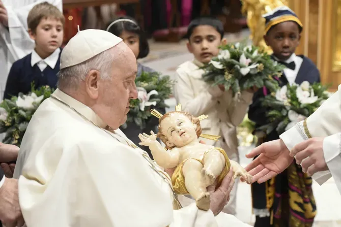 Pope Francis takes a figure of the Christ child in his arms at the end of the Vatican's Mass for the Nativity of the Lord on Dec. 24, 2023. | Vatican Media