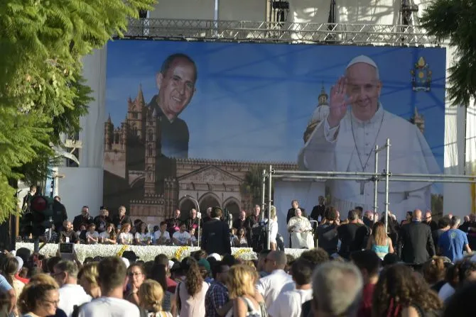 Pope Francis sits in front of an image of Blessed Giuseppe "Don Pino" Puglisi during a meeting with young people in the Archdiocese of Palermo, on the Italian island region Sicily, on Sept. 15, 2018. | Vatican Media.