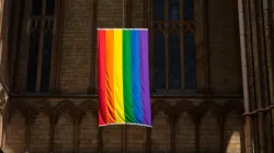A pride flag hangs from the Peterborough Cathedral in England in 2019. | Shutterstock
