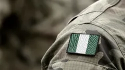 The flag of Nigeria on a military uniform. | Bumble Dee/Shutterstock.