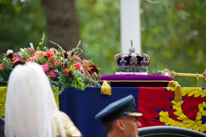 The Imperial State Crown, Sceptre, and wreath of symbolic flowers adorn the coffin of Her Late Majesty Queen Elizabeth II on the gun carriage for the funeral procession, Sept. 19, 2022. | Credit: Kelly Chow/Shutterstock