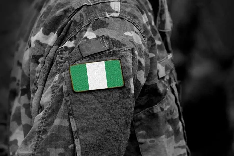 Flag of Nigeria on soldiers arm. Credit: Bumble Dee/Shutterstock