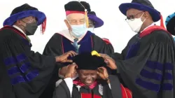 Sr. Prof. Agnes Lucy Lando being gowned by the Founder of Daystar of Daystar University, Dr. Donald K. Smith (centre), assisted by Prof. Abraham Waithima (right) and Prof. Michael Bowen (Left) on 24 February 2022. Credit: Daystar University, Corporate Affairs