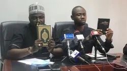 YOWICAN Chairman, Belusochukwu Enwere (right) holding a copy of the Bible and the National President of the National Council of Muslim Youth Organization, Sani Suleiman (left) holding a copy of the Coran. Credit: Courtesy Photo