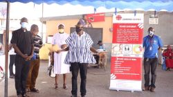 Samuel Zan Akologo, Executive Secretary of Caritas Ghana with Staff explaining to slum dwellers of Old Fadama in Accra about the donation at a presentation ceremony at the Sacred Heart Parish at Derby Avenue, Accra., on May 2, 2020. / Caritas Ghana