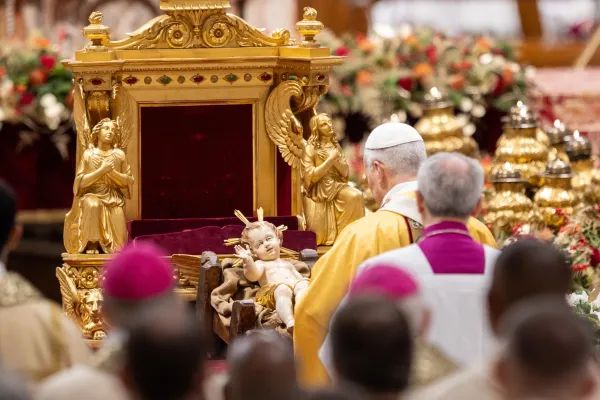 Pope Leo XIV venerates a statue of the Child Jesus during the celebration of Christmas Mass during the Night in St. Peter's Basilica on Dec. 24, 2025. / Credit: Daniel Ibanez/CNA.