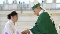 Pope Leo XIV hands a crucifix to a newly instituted catechist during Mass in St. Peter’s Square at the Vatican on Sept. 28, 2025. / Credit: Vatican Media