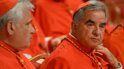 Italian Cardinal Giovanni Angelo Becciu (right) waits prior to the start of a consistory during which 20 new cardinals are to be created by Pope Francis on Aug. 27, 2022, in St. Peter’s Basilica in the Vatican. / Credit: ALBERTO PIZZOLI/AFP via Getty Images
