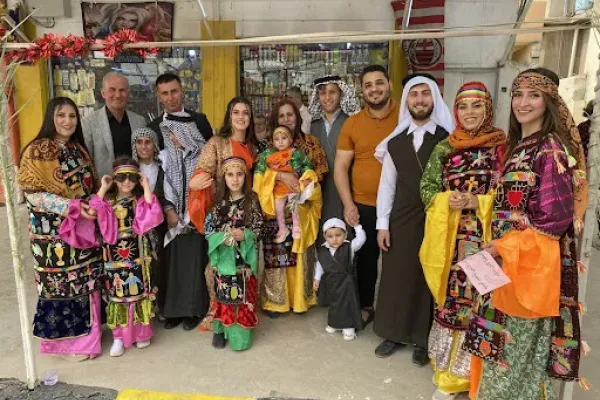 A Christian family in Qaraqosh sporting their traditional dressing for Holy Week in April 2022. Bashar Yameel Hanna/CNA