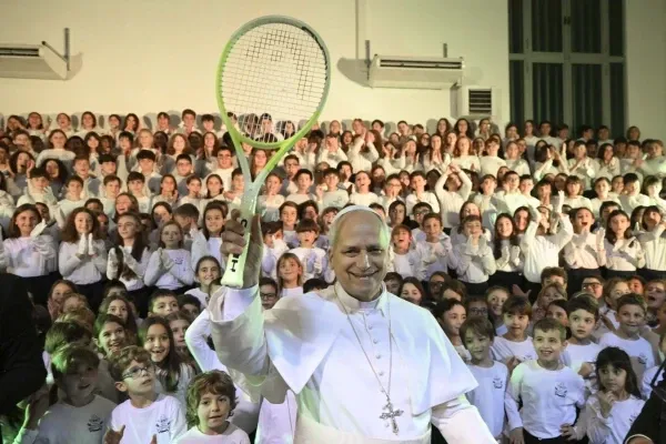 Pope Leo XIV holds up a tennis racket given to him by children of the Pope Paul VI Pontifical School in Castel Gandolfo on Dec. 16, 2025. / Credit: Vatican Media