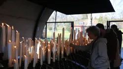 Pilgrims light candles at the Shrine of Our Lady of Lourdes in France. / Credit: Courtney Mares/CNA