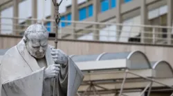 A statue of St. John Paul II holding a crucifix stands outside Rome's Gemelli University Hospital. | Credit: Daniel Ibáñez/CNA