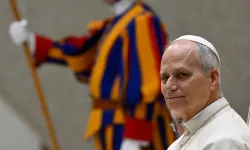 Pope Leo XIV sits during the Jan. 21, 2026, general audience alongside a Swiss Guard at the Vatican. | Credit: Vatican Media