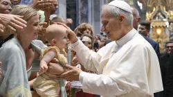 Pope Leo XIV blesses a baby during his Wednesday general audience in St. Peter’s Basilica on Aug. 13, 2025, at the Vatican. / Credit: Vatican Media